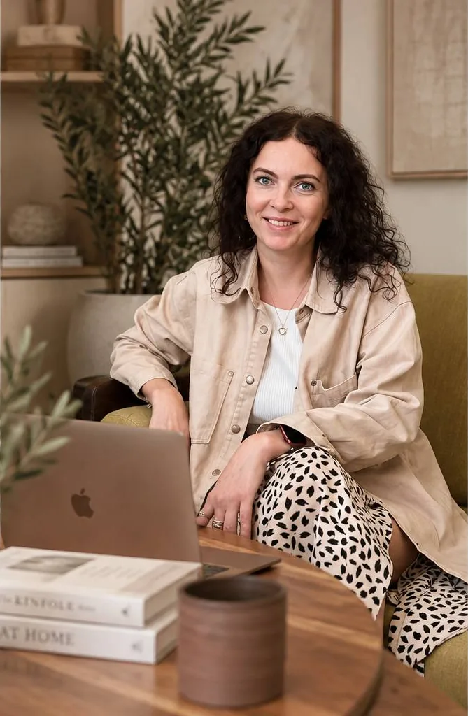 Liudmila, interior designer, working on a laptop in a living room